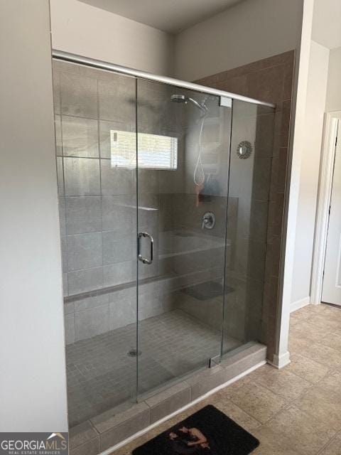 bathroom with a shower with door