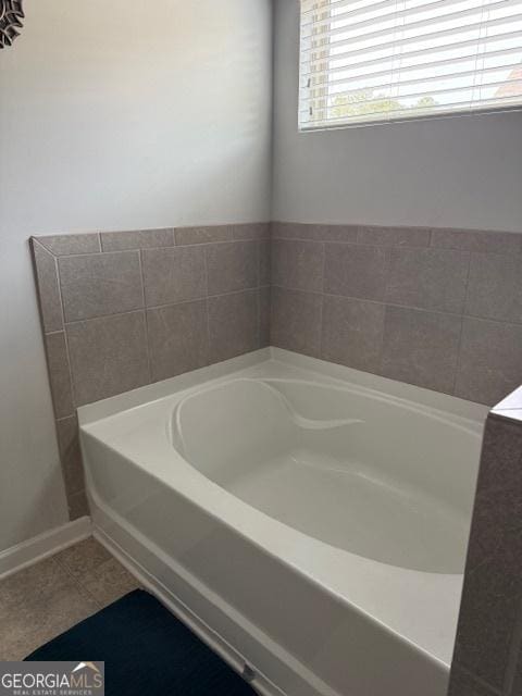 bathroom featuring tile patterned flooring and a tub