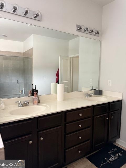 bathroom with vanity and a shower with shower door