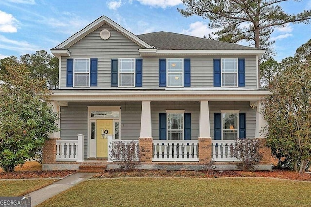 view of front of home featuring a porch and a front yard