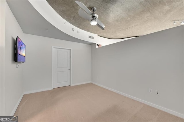 empty room featuring carpet flooring and ceiling fan