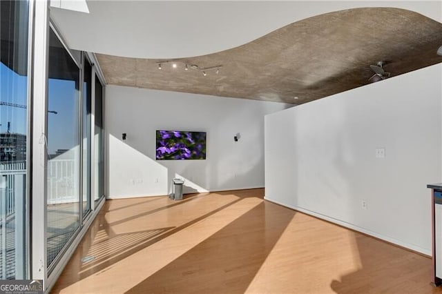 living room featuring expansive windows and hardwood / wood-style floors