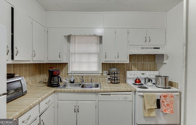 kitchen with sink, white cabinets, white appliances, and decorative backsplash