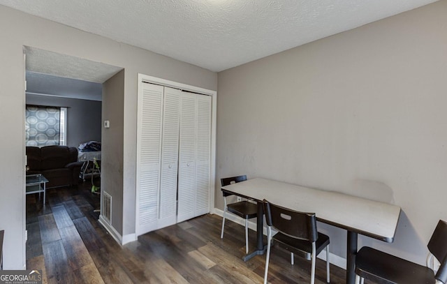 office with a textured ceiling and dark hardwood / wood-style flooring