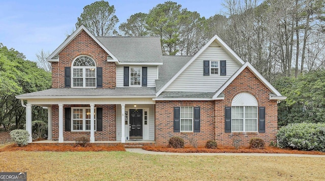 front of property with a porch and a front lawn