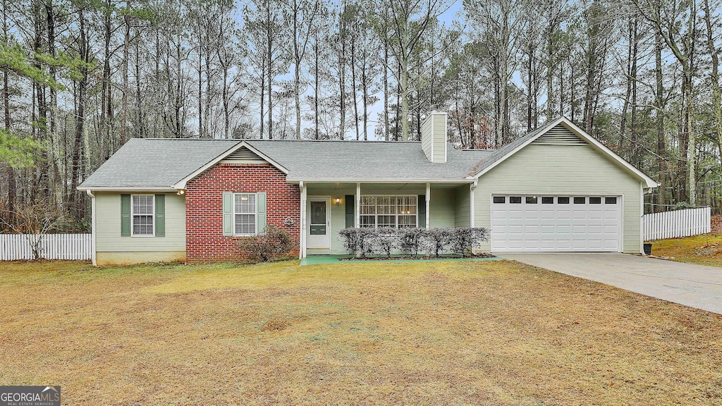 single story home with a garage and a front lawn