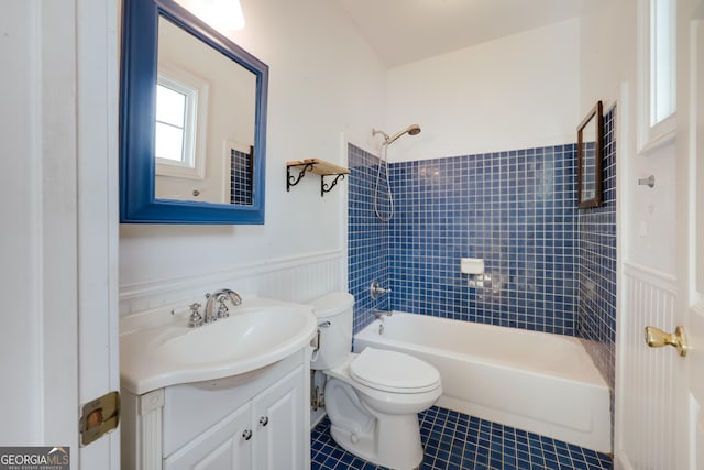 full bathroom featuring tile patterned floors, toilet, tiled shower / bath combo, and vanity