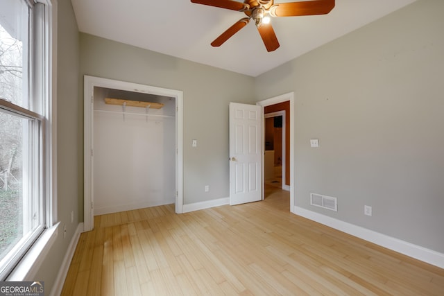 unfurnished bedroom with ceiling fan, a closet, and light hardwood / wood-style flooring