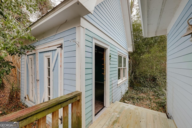 exterior space featuring a wooden deck and a storage shed