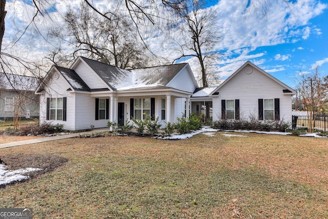 view of front of house with covered porch and a front yard