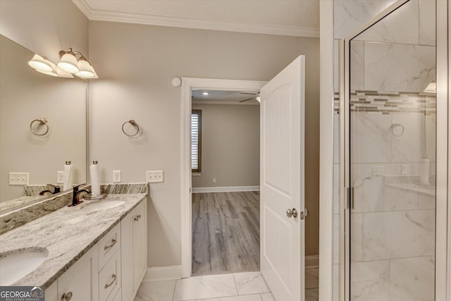 bathroom featuring ornamental molding, an enclosed shower, and vanity