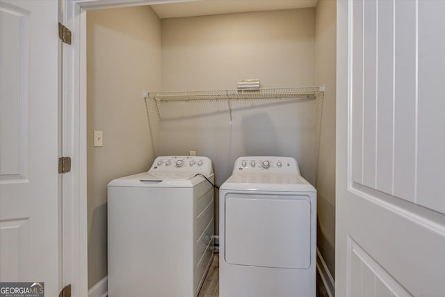 laundry room featuring hardwood / wood-style floors and independent washer and dryer