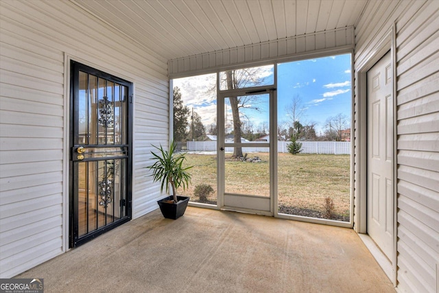 unfurnished sunroom with wood ceiling