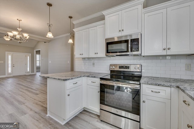 kitchen featuring appliances with stainless steel finishes, hanging light fixtures, tasteful backsplash, light stone counters, and white cabinets