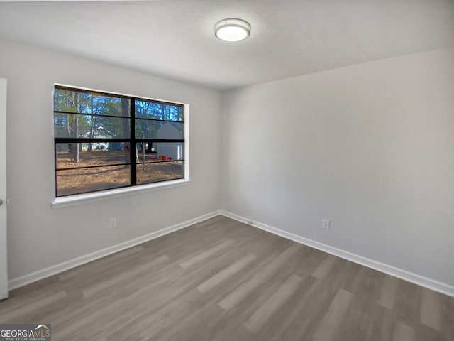 empty room featuring hardwood / wood-style floors and a healthy amount of sunlight