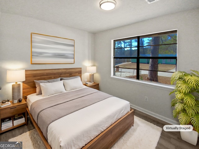 bedroom with hardwood / wood-style flooring