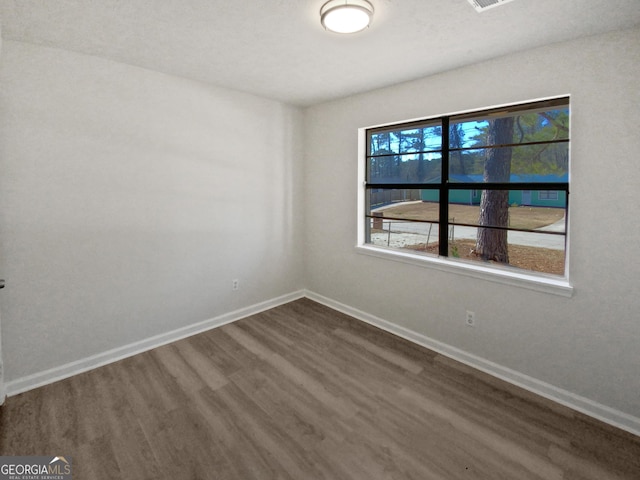 empty room with dark hardwood / wood-style floors