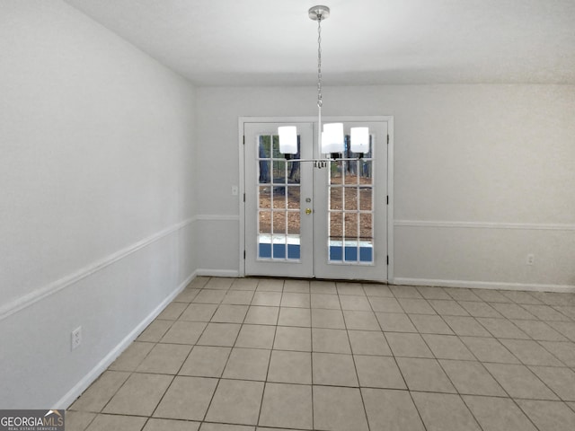 unfurnished dining area featuring light tile patterned floors