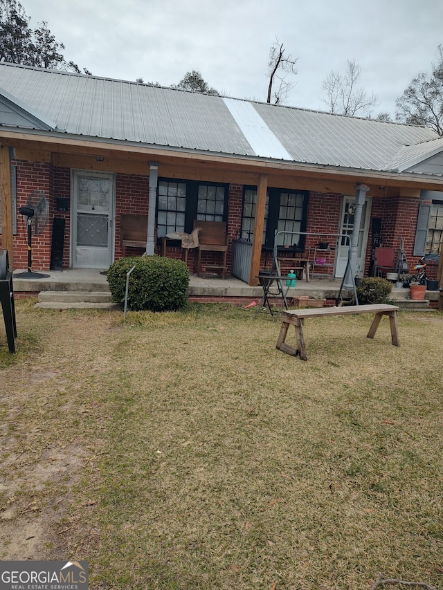 back of house with a lawn and a porch