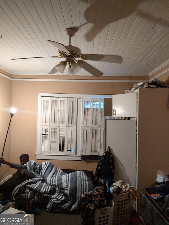 bedroom with ornamental molding, wood ceiling, and ceiling fan