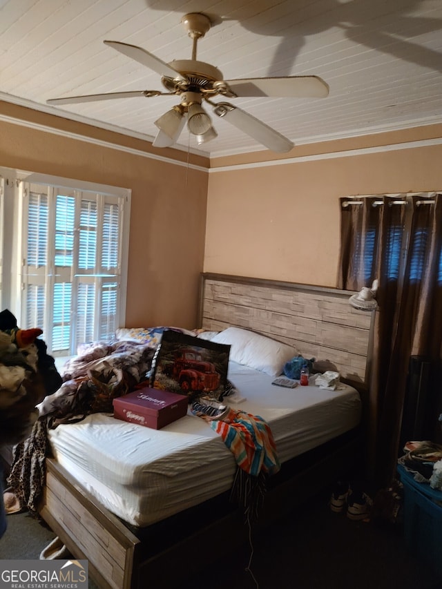 bedroom with ceiling fan and ornamental molding