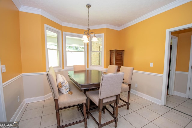 dining space with an inviting chandelier, ornamental molding, and light tile patterned flooring