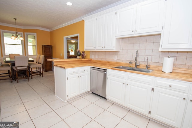 kitchen featuring sink, dishwasher, hanging light fixtures, white cabinets, and wood counters