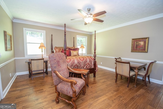 bedroom featuring dark hardwood / wood-style flooring, crown molding, multiple windows, and ceiling fan