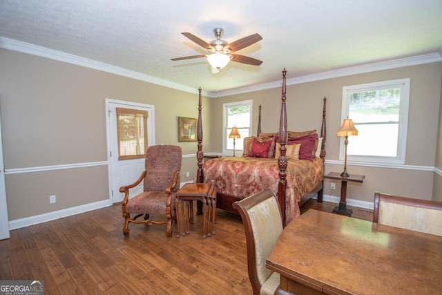 bedroom with crown molding, ceiling fan, dark wood-type flooring, and multiple windows