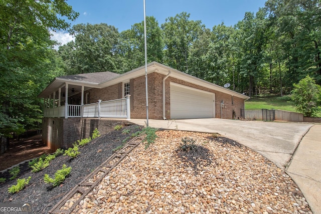 ranch-style house featuring a garage and covered porch