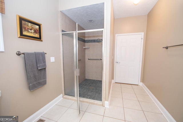 bathroom featuring tile patterned flooring and a shower with door