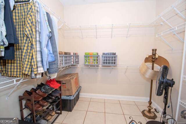 walk in closet with tile patterned flooring