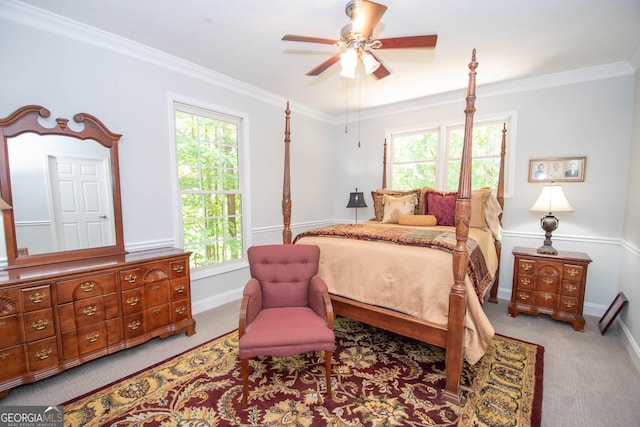 bedroom featuring multiple windows, ornamental molding, and ceiling fan