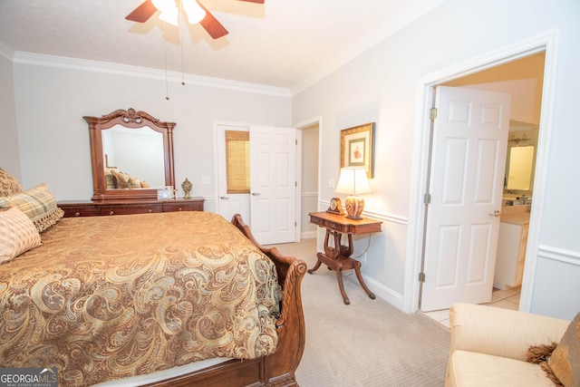 bedroom featuring crown molding, ceiling fan, ensuite bathroom, and light colored carpet