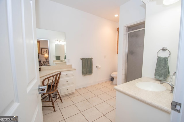 bathroom featuring tile patterned flooring, vanity, a shower with door, and toilet