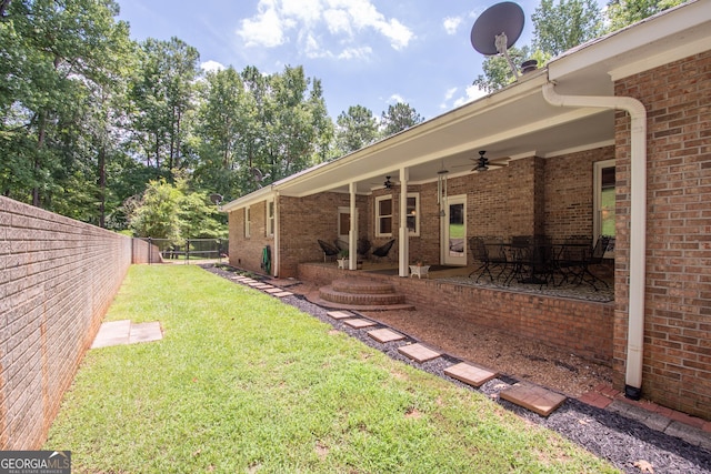 view of yard featuring ceiling fan and a patio area