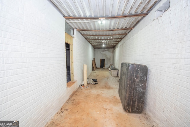 basement featuring brick wall