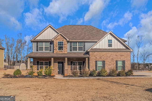 craftsman-style house with covered porch and a storage unit