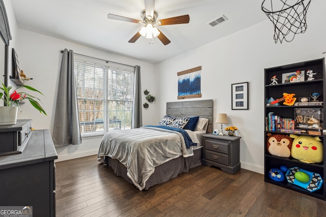 bedroom with multiple windows, dark hardwood / wood-style floors, and ceiling fan