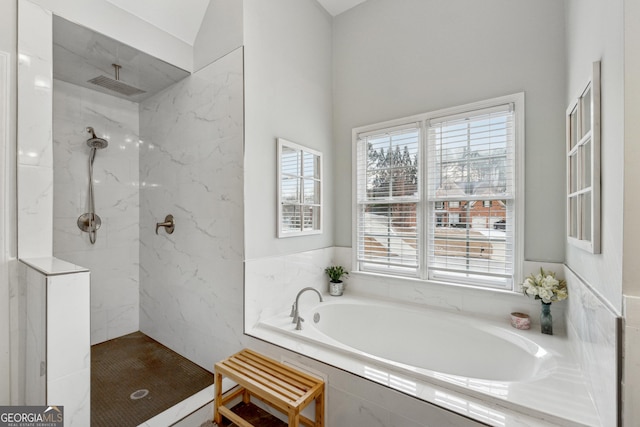 bathroom featuring independent shower and bath