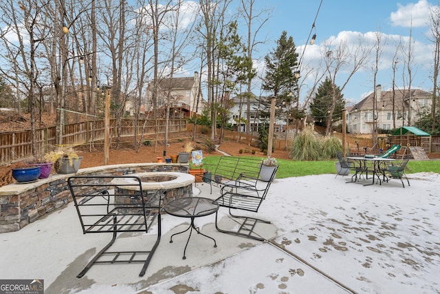 view of patio / terrace featuring a playground and an outdoor fire pit