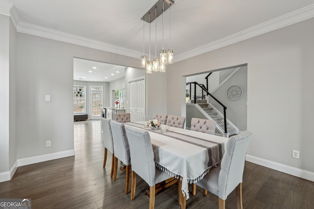 dining room with an inviting chandelier, dark hardwood / wood-style flooring, and crown molding