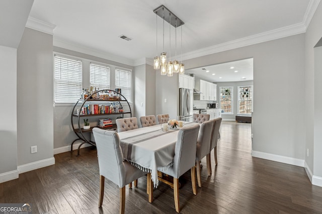 dining space featuring ornamental molding and dark hardwood / wood-style floors