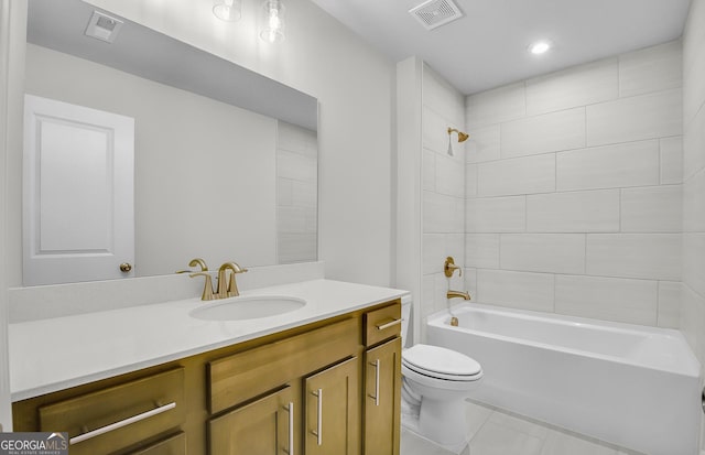 full bathroom with tiled shower / bath combo, vanity, tile patterned flooring, and toilet