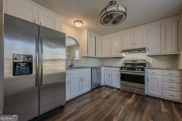 kitchen with stainless steel appliances, dark hardwood / wood-style flooring, sink, and white cabinets