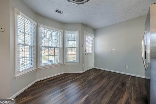 interior space featuring dark hardwood / wood-style floors and a textured ceiling