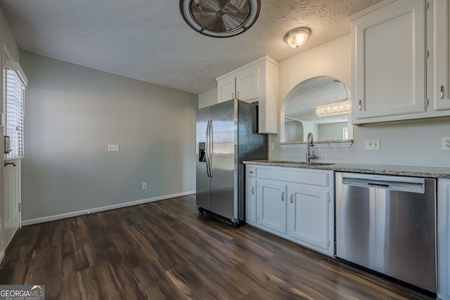 kitchen with sink, white cabinetry, a textured ceiling, dark hardwood / wood-style flooring, and stainless steel appliances