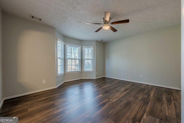 unfurnished room with dark hardwood / wood-style flooring, a textured ceiling, and ceiling fan