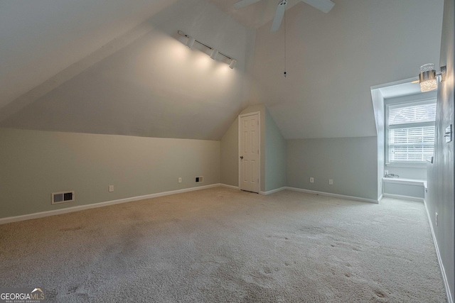 bonus room featuring ceiling fan, light colored carpet, and vaulted ceiling