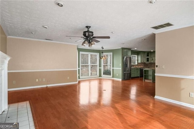 unfurnished living room with hardwood / wood-style floors, a textured ceiling, ornamental molding, and ceiling fan